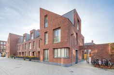 a brick building with many windows on the side