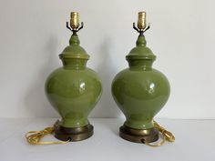 two green vases sitting next to each other