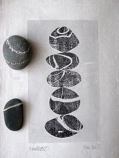 some rocks are sitting on a towel next to a rock and a paper with the word love written in it