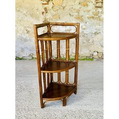 Vintage, mid-century bamboo and rattan three-tiered corner shelf on legs, from the 1960s. This beautiful piece features a design comprising a bamboo frame with curved rattan, and three triangle-shaped shelves in dark brown wood, each shelf measuring 30.5 cm wide and 24.5 cm deep. Both sides and the back of the piece feature a beautiful bentwood design, with oval/ellipsoid shapes. The rear leg is slightly curved outwards, which has been integrated into the shelf's overall design. The piece is in very good, original, vintage condition, with some light marks, signs of age and previous use commensurate with the passage of time, as well as a beautiful patina of time, on the frame, shelves, woodwork, borders and feet (see multiple photos.) The surface has only been gently cleaned and polished, i Frame Shelves, Display Cabinet Decor, Pouf Chair, Dressing Table Desk, Ceramic Wall Decor, Wooden Wall Shelves, Garden Table And Chairs, Wood Bookcase, Bamboo Frame