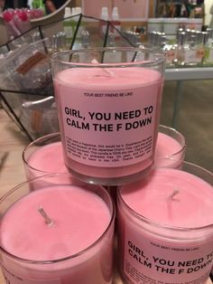 pink candles are stacked on top of each other with the words girl, you need to calm the f down