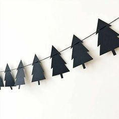 black paper christmas trees hanging on a string