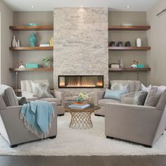 a living room filled with furniture and a fire place in the middle of a room