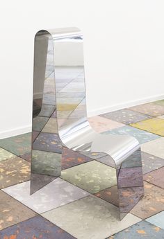 a chair sitting on top of a tiled floor