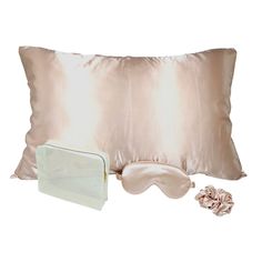 a satin pillow, eye mask and hair clip