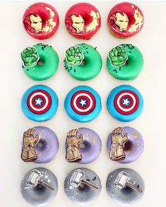 the donuts have different designs on them and are decorated with captain america stickers