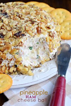 a cheese ball is on a plate with crackers