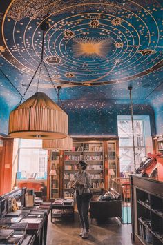 a woman is standing in the middle of a library