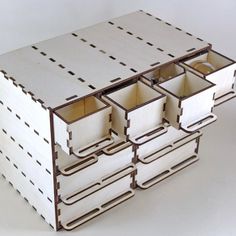 four drawers are stacked on top of each other in the shape of a box with holes