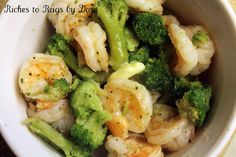 a white bowl filled with shrimp and broccoli