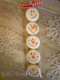 three decorated cookies in the shape of snowmen