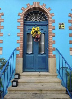 a blue front door with sunflowers on it