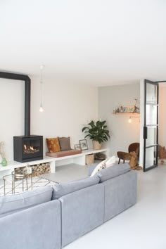 a living room filled with furniture and a fire place next to a wall mounted tv