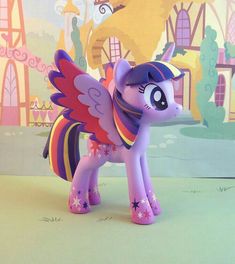 a little pony that is standing in front of a wall