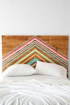 the headboard is made out of wood and has multicolored stripes on it