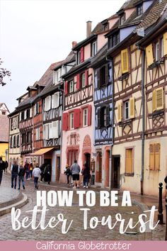 people walking down a cobblestone street in an old european town with text overlay how to be a better tourist