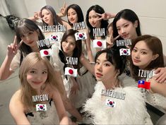 a group of young women posing for a photo with their name tags in front of them