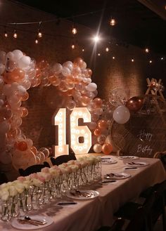 the table is set with champagne glasses and balloons for an elegant celebration at 16 twenty