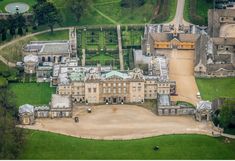 an aerial view of a large mansion in the countryside