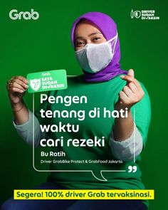 a woman wearing a green shirt and purple head scarf holding up a sign that reads, pengeng tenang di hat woktu cari rezekki