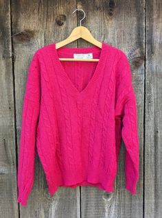 Hot pink wool cable knit sweater, 1990s vintage. A high-quality warm winter pullover in an amazing statement color! Features a lightweight neon pink Shetland wool, low V neck, classic cable knit weave, comfy oversize fit, and lots of edgy Y2K chic... Would look perfect grunged out with shredded jeans and leather boots, or given a preppy feel with a turtleneck and slacks...;) Brand : Talbots made in Hong Kong 100% pure Shetland wool, spun in Scotland Labeled size L All measurements taken with garment lying flat, double where necessary roughly 28 inches shoulder seam to shoulder seam 26 inches pit to pit 17 inches across hem 16 inches from the base of the V neckline to the hem 27 inches from the top of the neckline in back to the hem 18 inch sleeve length A fair amount of general distressing Thick Pink Sweater, Y2k Chic, Edgy Y2k, Dark Pink Sweater, Pink V-neck Sweater For Winter, Dark Pink Knit Sweater, Winter Hipster, Oversized Hot Pink Sweater, Shredded Jeans