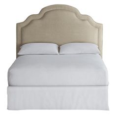 an upholstered bed with white linens and pillows on the headboard, isolated against a white background