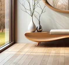 a wooden table sitting in front of a window next to a vase filled with flowers