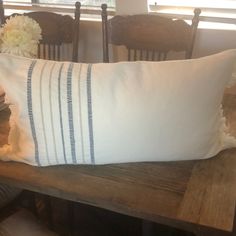 a white pillow sitting on top of a wooden table