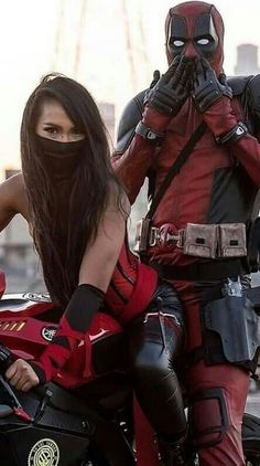 two people dressed up as deadpool and harley davidson riding on a motorbike