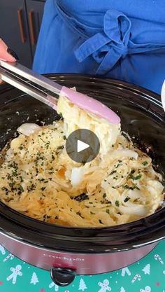 a person is stirring some food in a slow cooker