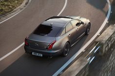 a silver car driving down a winding road