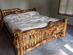 a bed made out of logs in a room with carpeted flooring and windows