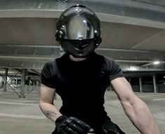 a man riding a motorcycle wearing a helmet and gloves