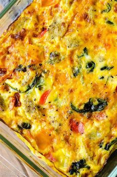 a casserole dish with vegetables and cheese in a glass baking dish on a table