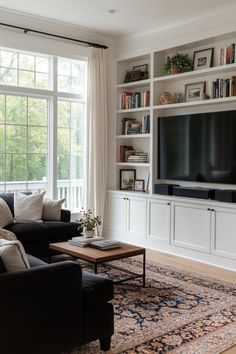 a living room filled with furniture and a flat screen tv on top of a book shelf