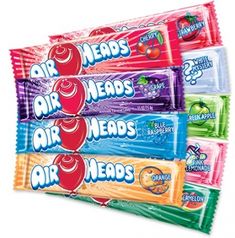 four air heads candy bars stacked on top of each other in front of a blue background