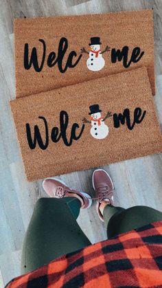 someone standing in front of a welcome mat with a snowman on it and the words welcome