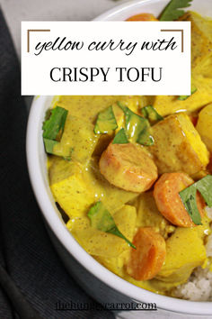 yellow curry with crispy tofu in a bowl on top of rice and garnished with cilantro