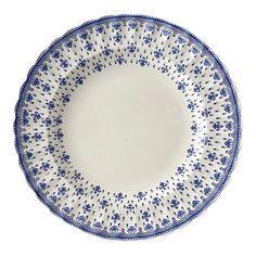 a blue and white plate with flowers on it's rim, against a white background