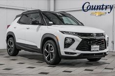 a white suv parked in a garage with the words country on it's side