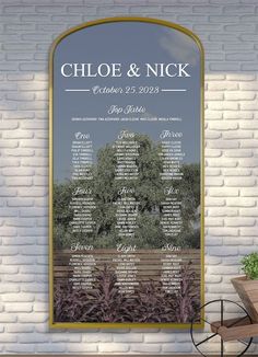 a wedding seating chart is displayed on a brick wall in front of a wooden bench