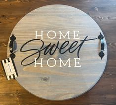 a sign that says home sweet home on the side of a wooden table with a price tag