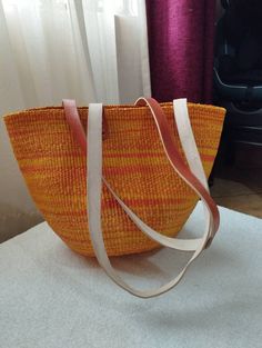 "Orange and yellow sisal tote bag DIMENSIONS Bottom width: 10\"/25.5cm Top width: 14\"/35.56cm Depth: 10\"/25.5cm Straps: 15\"/38cm SHIPPING All orders ship via DHL Express (3-5) days delivery time." Handheld Beach Bag For Shopping, Woven Handheld Bag For Daily Use, Handheld Woven Bag For Daily Use, Woven Double Handle Shoulder Bag For Shopping, Yellow Handheld Bag For Shopping, Eco-friendly Orange Rectangular Straw Bag, Yellow Handheld Shopping Bag, Woven Double Handle Bags For Shopping, Woven Shopping Bags With Double Handle