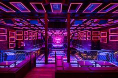 the interior of a nightclub with purple lighting