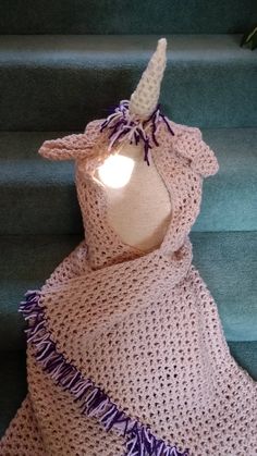 a crocheted dress sitting on top of some stairs