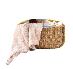 a woven basket with clothes in it