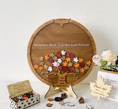 a wooden sign that says memories made together last forever with fall leaves in the shape of a tree