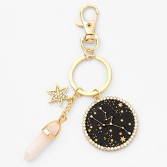 a black and gold keychain with stars on the front, an acrylic pen