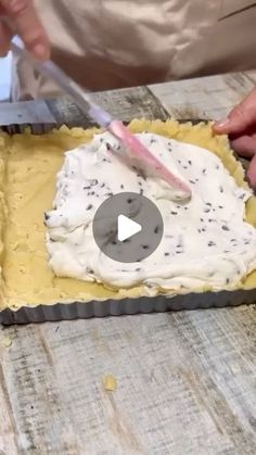 a person cutting into a cake with a knife