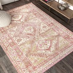 an area rug in a living room with wood flooring